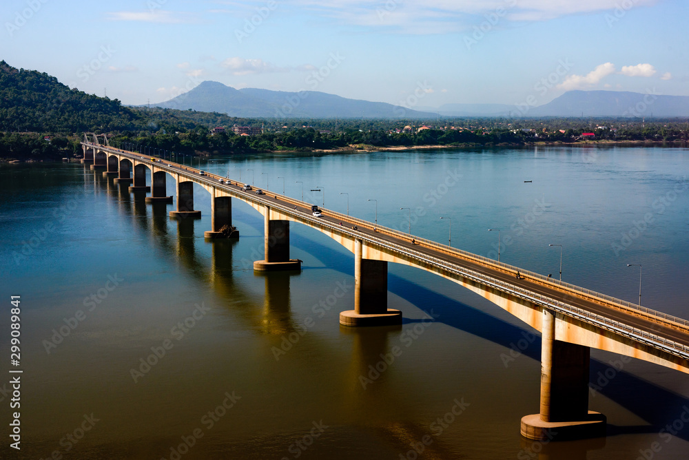 Bridge over the Mekong River of Pakse, Loas In the evening, the sun shines through the concrete of the bridge, looking beautiful and outstanding. 
