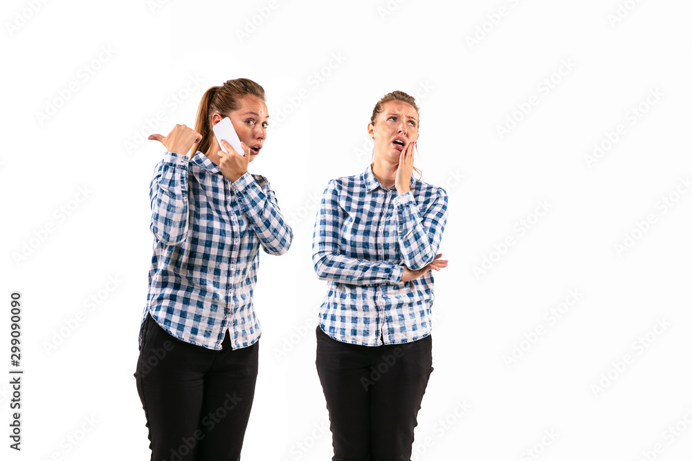 Young handsome woman arguing with herself on white studio background. Concept of human emotions, expression, mental issues, internal conflict, split personality. Half-length portrait. Negative space. Young handsome woman arguing with herself on white studio background. Concept of human emotions, expression, mental issues, internal conflict, split personality. Half-length portrait. Negative space.