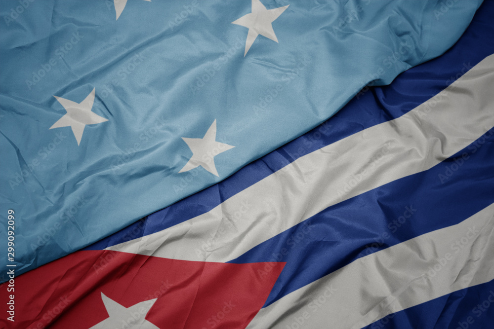 Fototapeta premium waving colorful flag of cuba and national flag of Federated States of Micronesia .