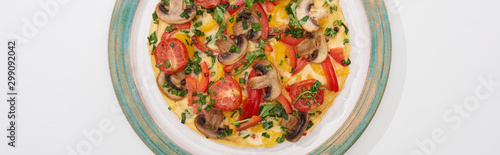 top view of plate with tasty omelet with tomatoes and mushrooms for breakfast on white table