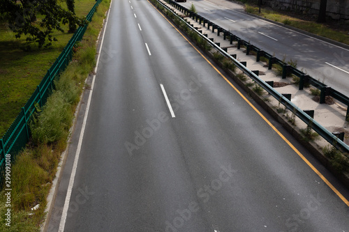 Divided urban highway  overhead view with concrete and guardrail median  horizontal aspect