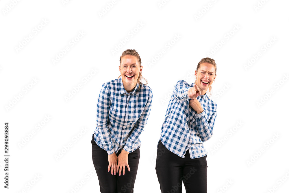 Young handsome woman laughting with herself on white studio background. Concept of human emotions, expression, mental issues, internal conflict, split personality. Half-length portrait. Negative space Young handsome woman laughting with herself on white studio background. Concept of human emotions, expression, mental issues, internal conflict, split personality. Half-length portrait. Negative space