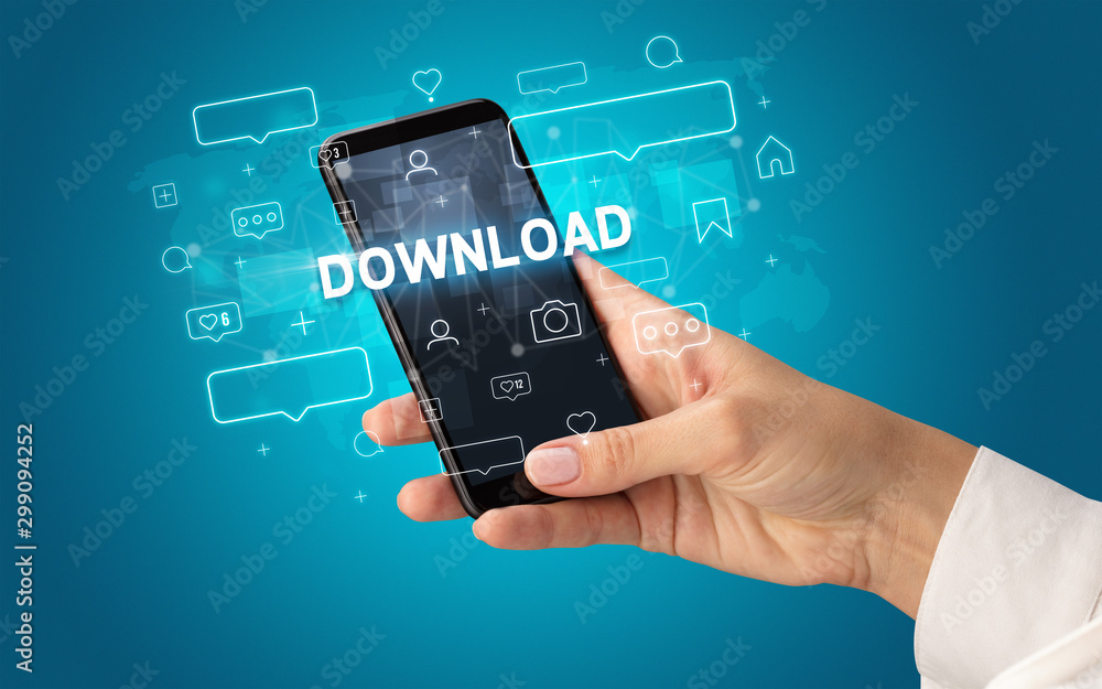 Female hand typing on smartphone with DOWNLOAD inscription, social media concept Female hand typing on smartphone with DOWNLOAD inscription, social media concept
