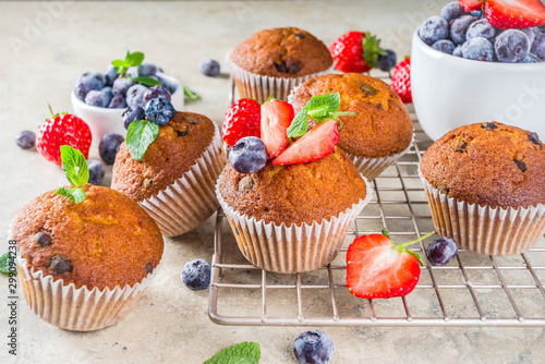 Homemade vanilla muffins or cupcakes with berries