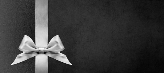 black gift card with silver ribbon bow, black friday and cyber monday concept, copy space template