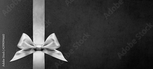 black gift card with silver ribbon bow, black friday and cyber monday concept, copy space template