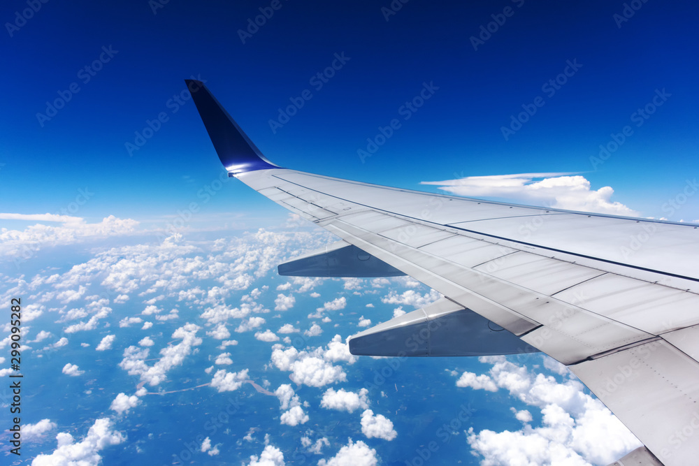 Clouds and airplane wing seen from window Clouds and airplane wing seen from window