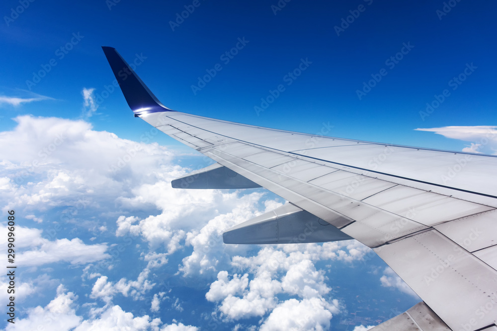 Clouds and airplane wing seen from window Clouds and airplane wing seen from window