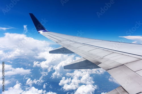 Clouds and airplane wing seen from window