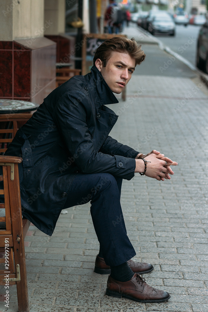 portrait of an attractive young man in a blue suit in the city portrait of an attractive young man in a blue suit in the city