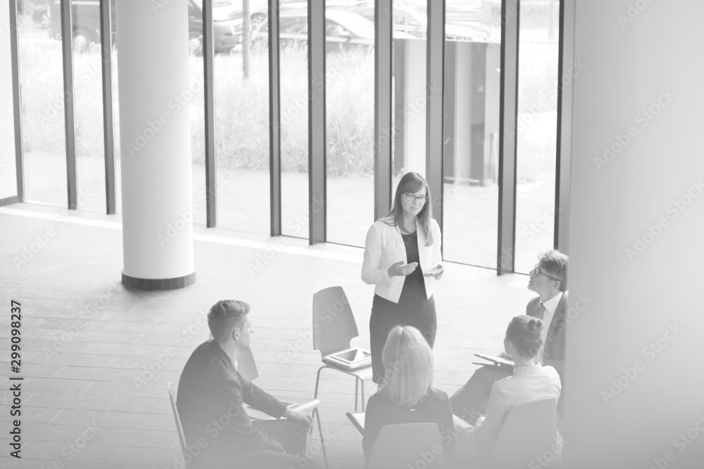 Black and white photo of colleagues planning while sitting during meeting at office Black and white photo of colleagues planning while sitting during meeting at office