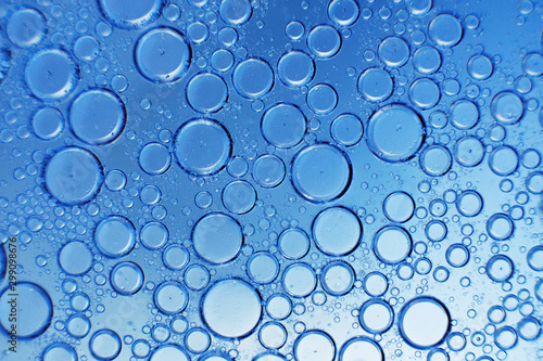 abstract light blue background with oil circles . bubbles of water close up . oil bubbles in the water macro. circle bubbles background