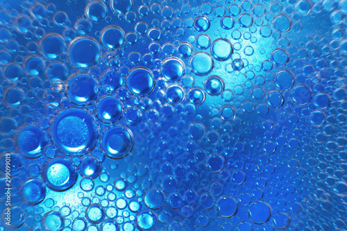 abstract light blue background with oil circles . bubbles of water close up . oil bubbles in the water macro. circle bubbles background