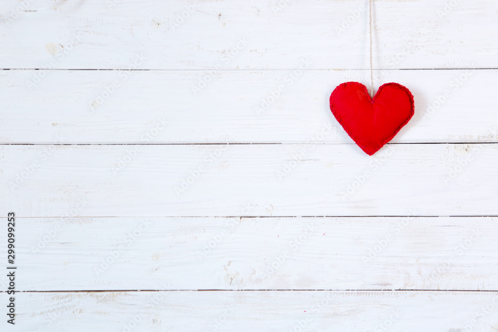 Love heart on string against white wooden texture background. Valentines day card concept Love heart on string against white wooden texture background. Valentines day card concept