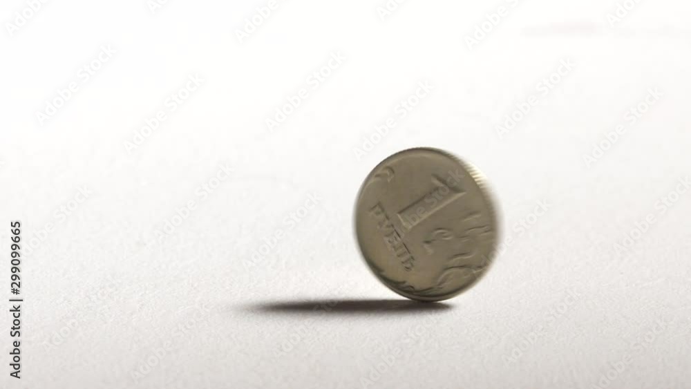 1 Russian ruble coin spinning and dropping on desk. One rouble currency of Russian Federation. 1 Russian ruble coin spinning and dropping on desk. One rouble currency of Russian Federation.