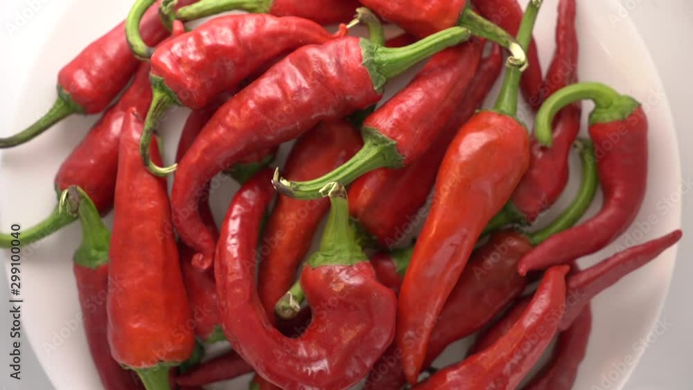 Fresh red hot chili peppers rotating close-up top view. Fresh red hot chili peppers rotating close-up top view.