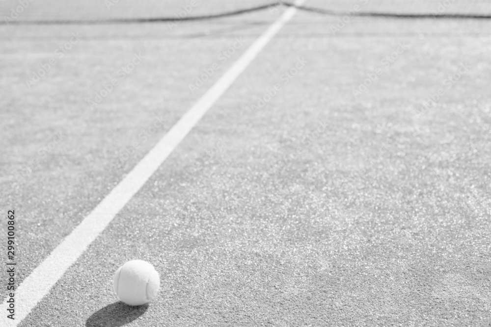 Tennis ball on red court during sunny day Tennis ball on red court during sunny day