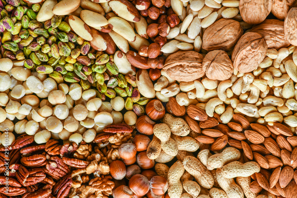 Obraz premium Natural healthy background made from different kinds of mix nuts like walnuts, hazelnut, pistachio, almond, cashew, pecans.