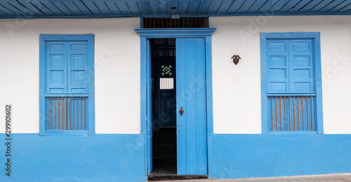 House with hallway and two windows and a door in blue and orange in Filandia Quindío, Colombia