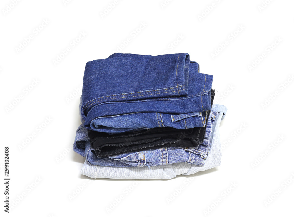 Stack of various blue jeans on white background. Stack of various blue jeans on white background.