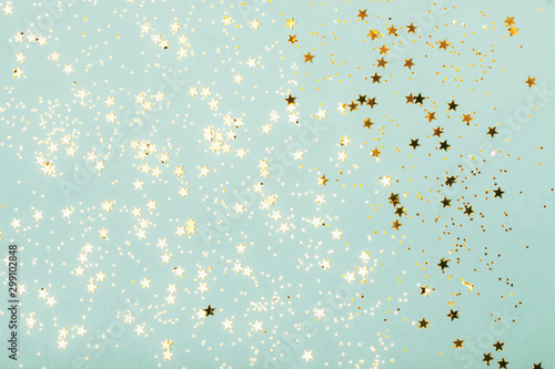 Trendy mint background with gold stars. The concept of celebrations, the Day of St. Valentine, Christmas, New Year, holiday, birthday, etc.