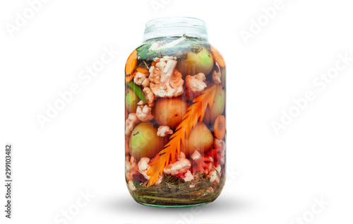 Various vegetables pickled in a jar isolated on white
