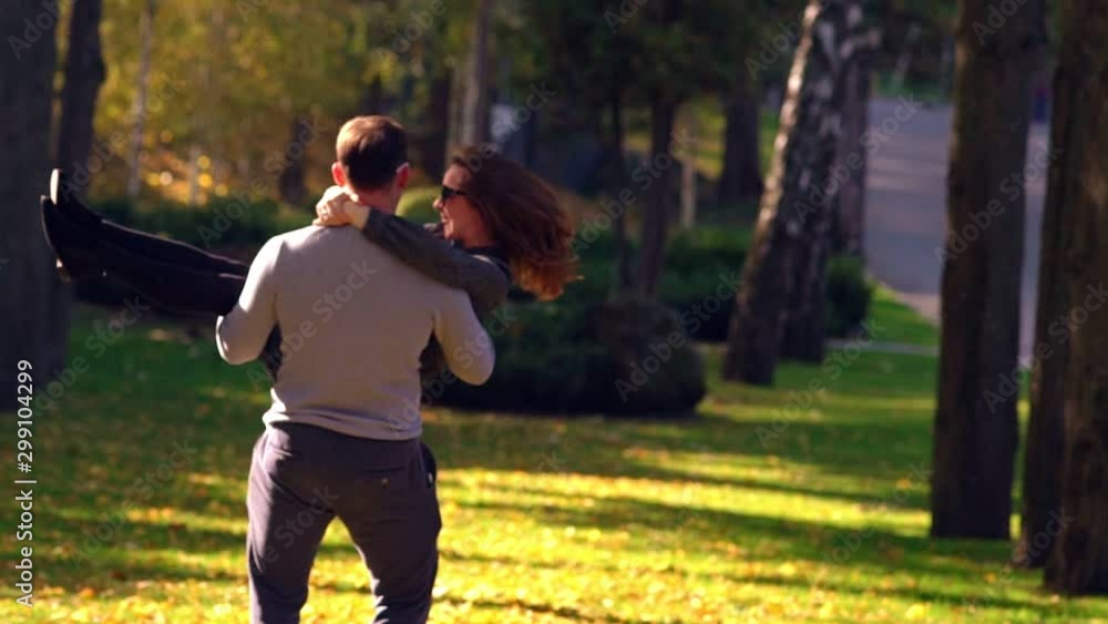 Young happy man spinning with woman in his arms Young happy man spinning with woman in his arms