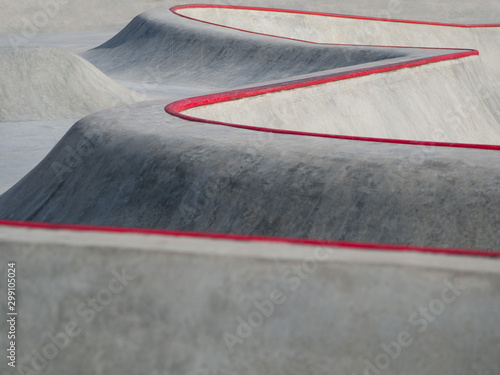 Closeup of skatepark with abstract lines of concrete pump track