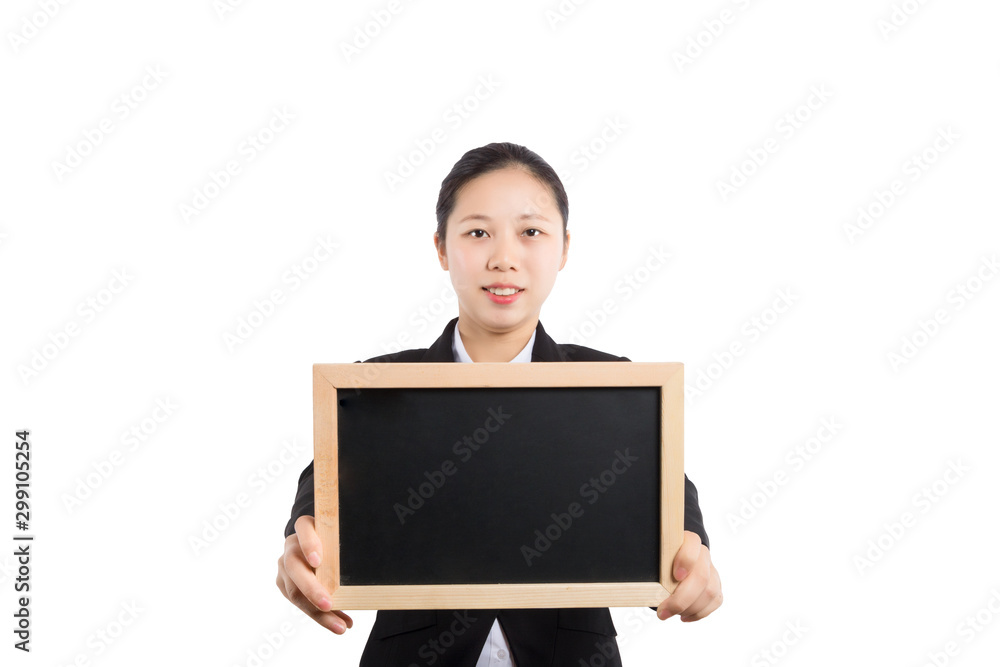 Portrait of a teacher in a classroom. The teacher stands at the blackboard with a textbook in one hand, holds his thumb up and looks away. Portrait of a teacher in a classroom. The teacher stands at the blackboard with a textbook in one hand, holds his thumb up and looks away.