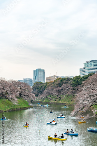 CHIYODA, TOKYO PREFECTURE, JAPAN - March 27, 2019: Visitors enjoying the scenario surrounded by Chidori-ga-fuchi Moat's cherry blossoms (sakura) on a rental boat ride.