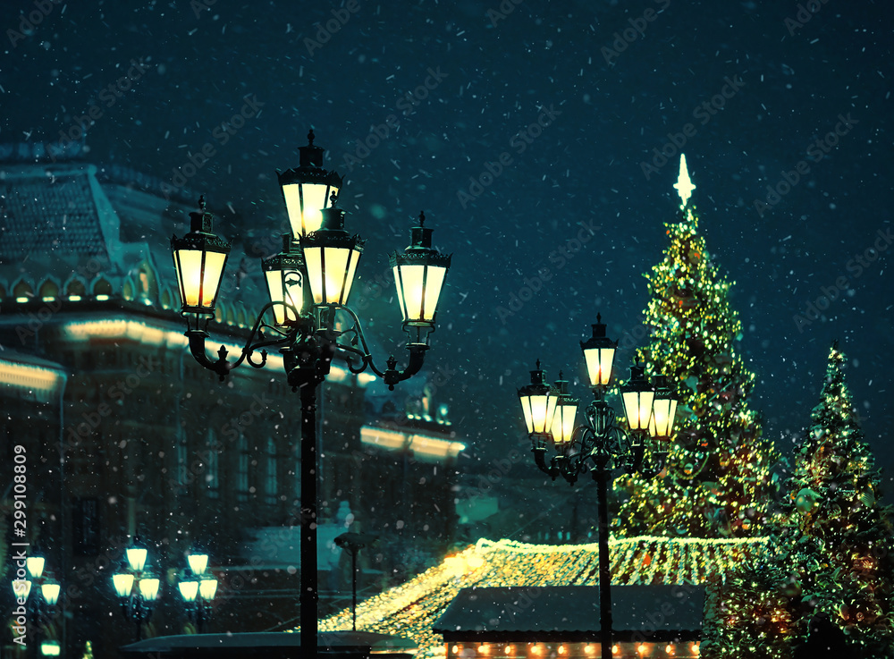 Beautiful retro lantern and christmas tree in winter snowing night. Christmas and new year winter holiday background. soft selective focus. 
