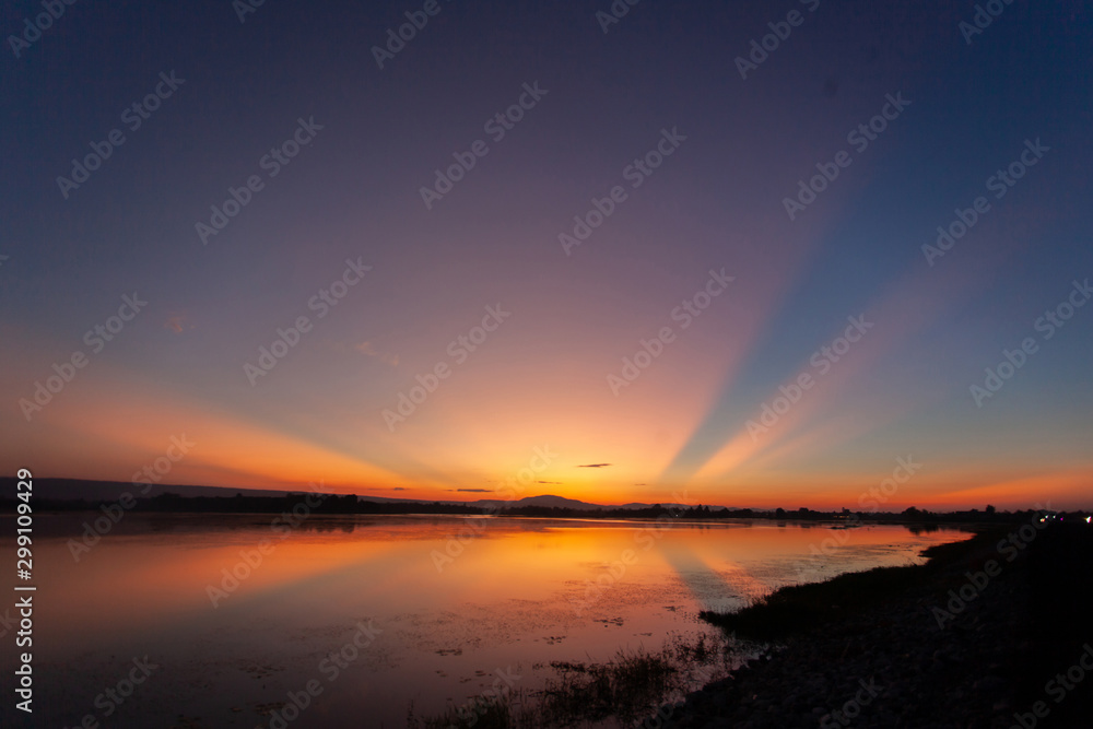 Beautiful sunset reflected in the lake.Fiery orange sunset sky. Beautiful sky