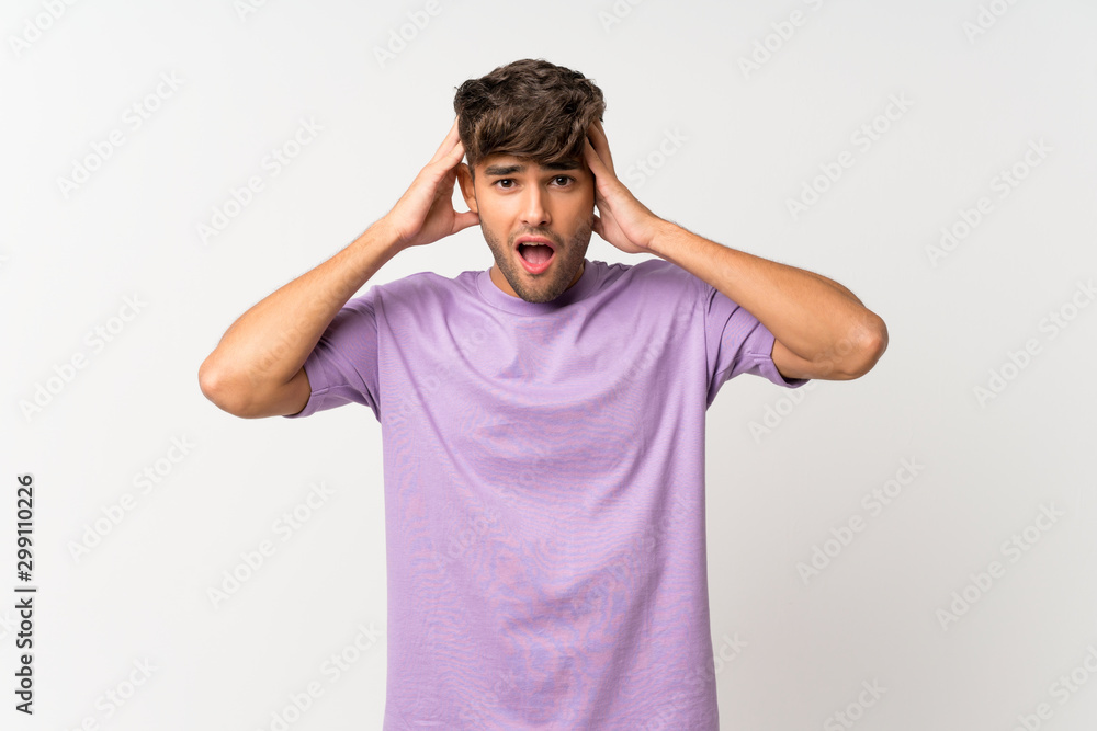 Young handsome man over isolated white background with surprise expression Young handsome man over isolated white background with surprise expression