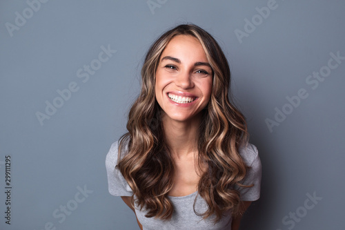 Portrait of young beautiful cute cheerful girl smiling looking at camera. photo