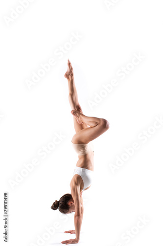 Beautiful sporty yogi girl practices yoga isolated on white background.
