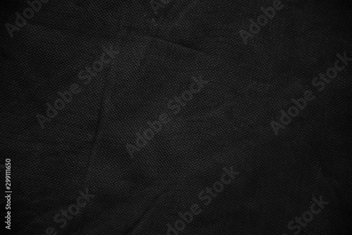 Black canvas pattern background. Surface with spotlight, dark tone.