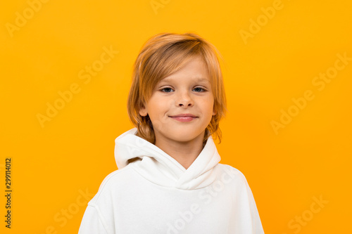 portrait of a cute boy on a background of an orange wall