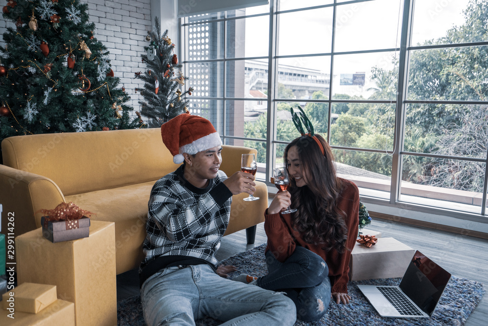 Merry Christmas and happy holidays tradition Cute young couple smile make eyes contact each other embrace light up, celebrate seasonal men and women attractive each other. Christmas concept.