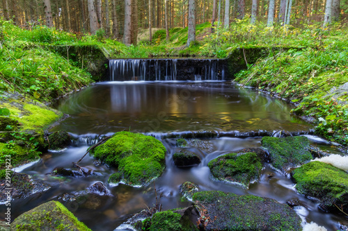 Small weir on brook in forest  long exposure photography  Czech landscape