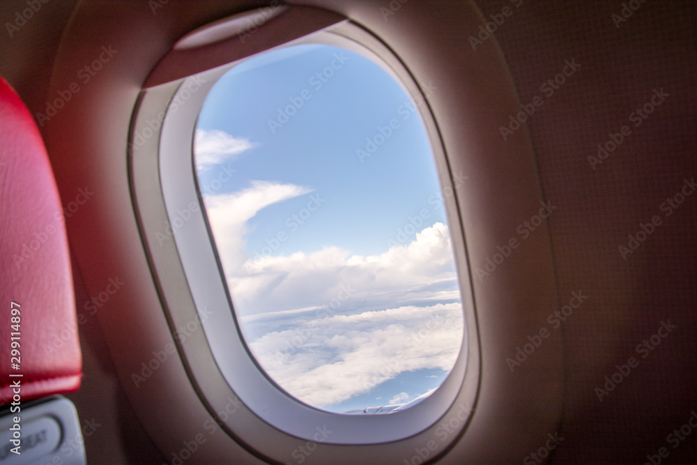 Looking at the view through the plane window, saw a group of white clouds. Looking at the view through the plane window, saw a group of white clouds.