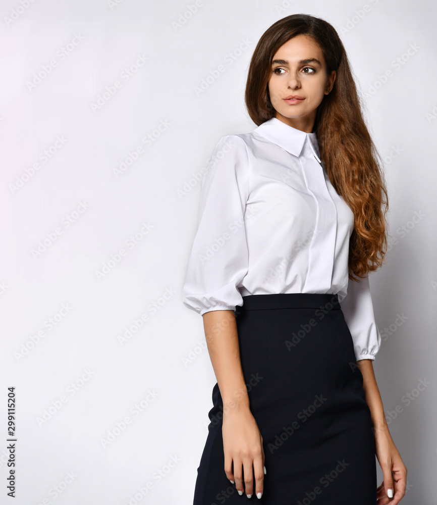 beautiful woman office manager posing in a new casual white blouse and classic straight dark skirt beautiful woman office manager posing in a new casual white blouse and classic straight dark skirt