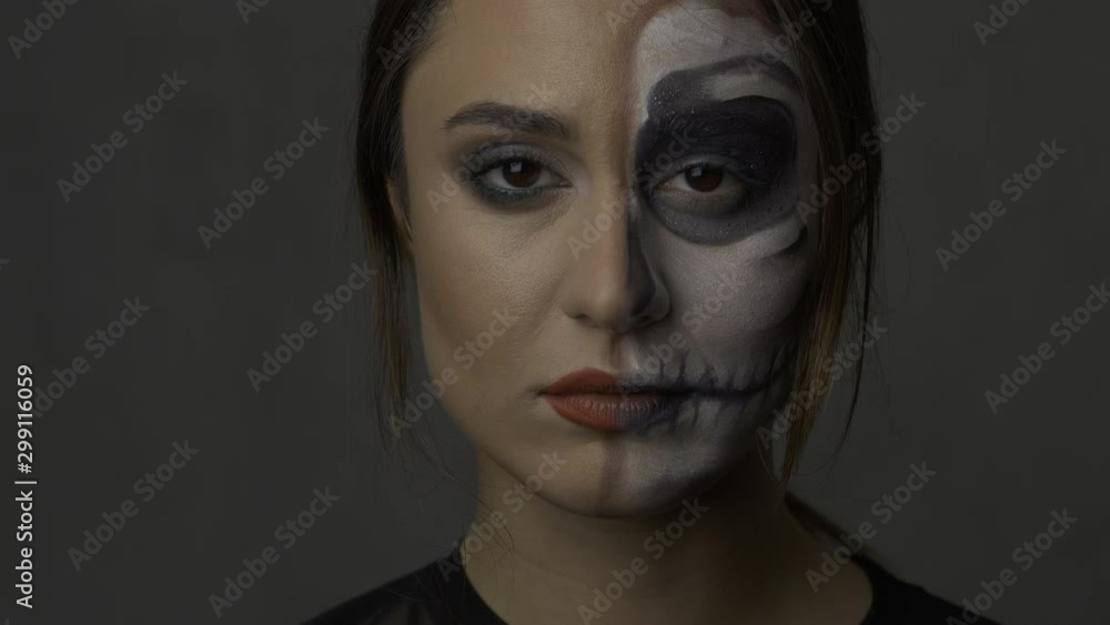 piercing gaze of a girl with a painted face. Theme of masquerade piercing gaze of a girl with a painted face. Theme of masquerade