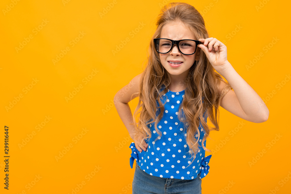 girl with glasses on a yellow background with poor eyesight