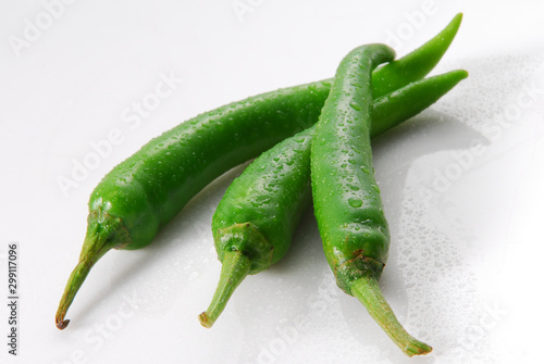 green chili peppers on white background