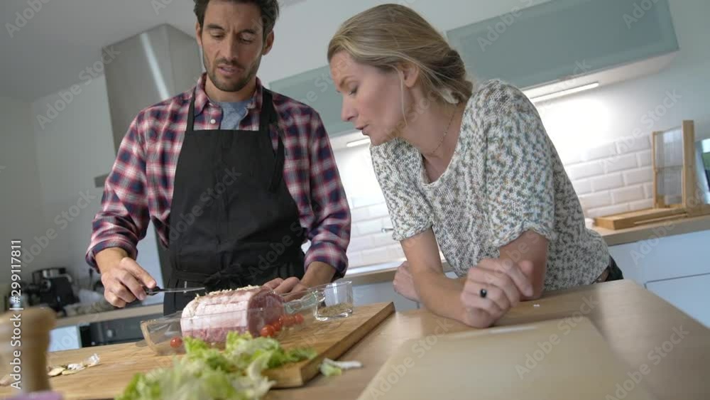 young couple preparing a meal in the kitchen young couple preparing a meal in the kitchen