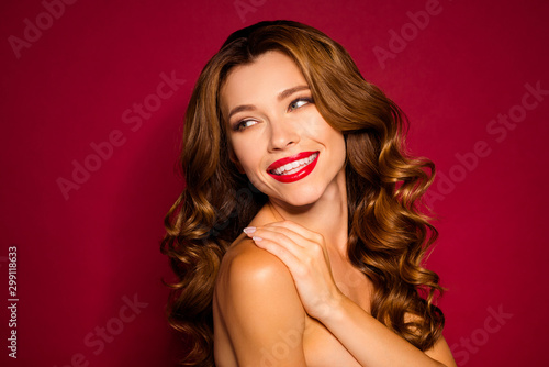 Close-up portrait of her she nice attractive cheerful cheery gentle wavy-haired girl touching silky clean clear skin isolated on bright vivid shine vibrant red maroon burgundy marsala color background