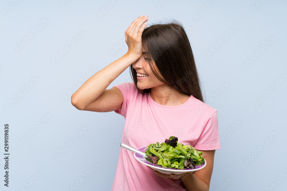 Young woman with salad over isolated blue background has realized something and intending the solution Young woman with salad over isolated blue background has realized something and intending the solution