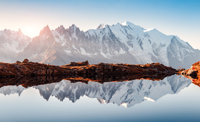 Foto auf Leinwand Schlafzimmer Unglaubliche Aussicht auf klares Wasser und Himmelsreflexion auf dem Chesery-See (Lac De Cheserys) in den französischen Alpen. Monte Bianco Berge reichen im Hintergrund. Landschaftsfotografie, Chamonix.  © Ivan Kmit