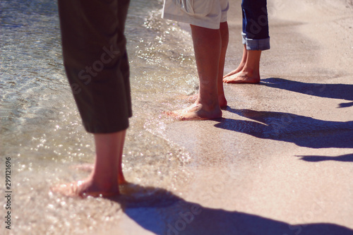 People standing on a beach in Door County, Wisconsin with their feet in the water