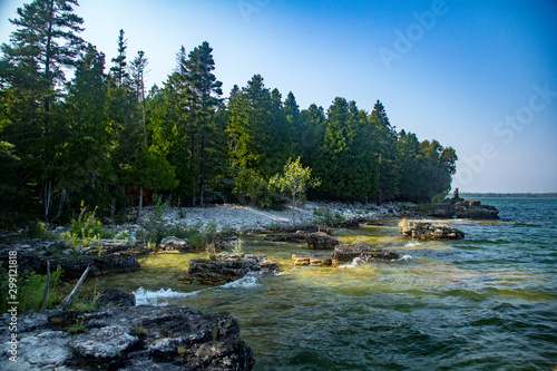Rocky beach and treeline at Toft Point in Door County, Wisconsin photo